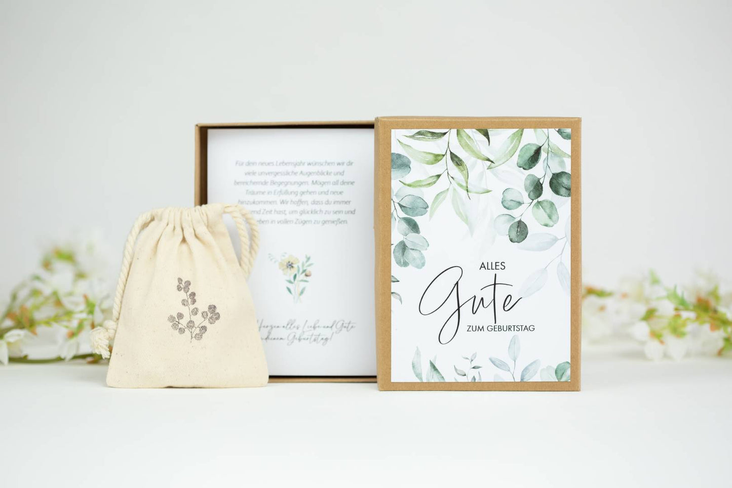 a bag and a card inside of a box