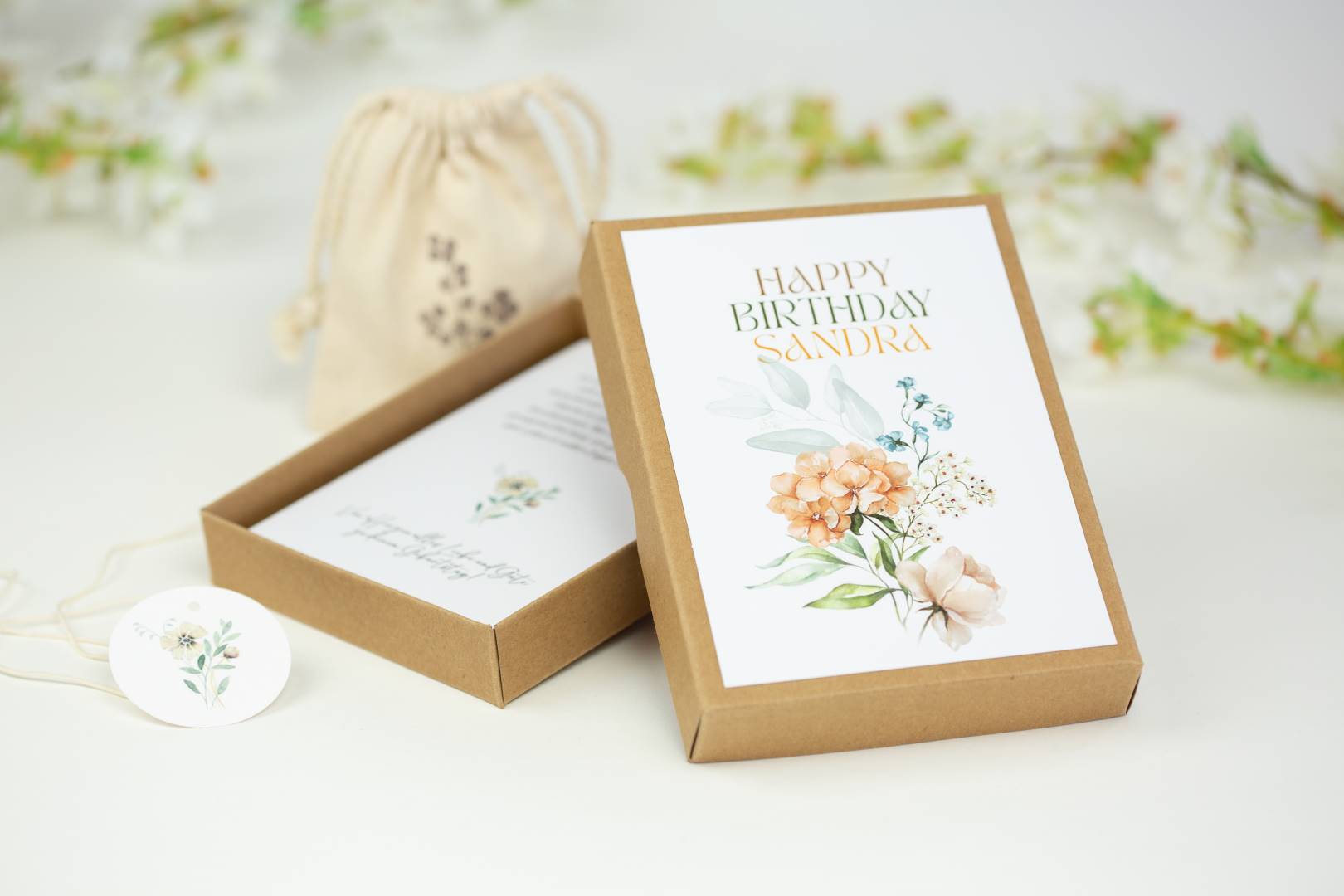 a birthday card in a box with a tag