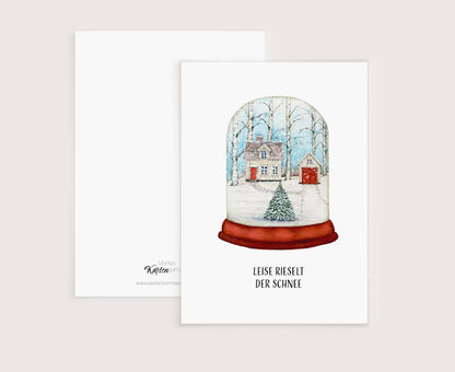 a christmas card with a snow globe on it