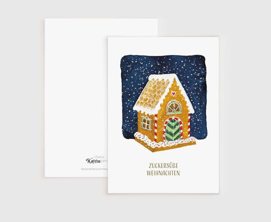 a card with a gingerbread house on it