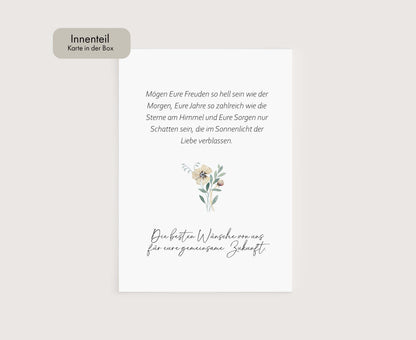 a white card with a flower on it