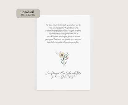 a white card with a flower on it