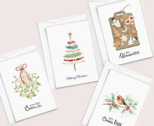 four christmas cards with watercolor designs on them