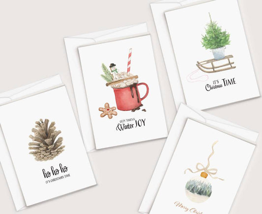 four christmas cards with a cup of coffee and a pine cone