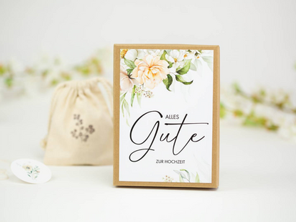 a card with a floral design on it next to a drawstring bag