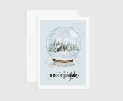 a card with a snow globe with a house inside