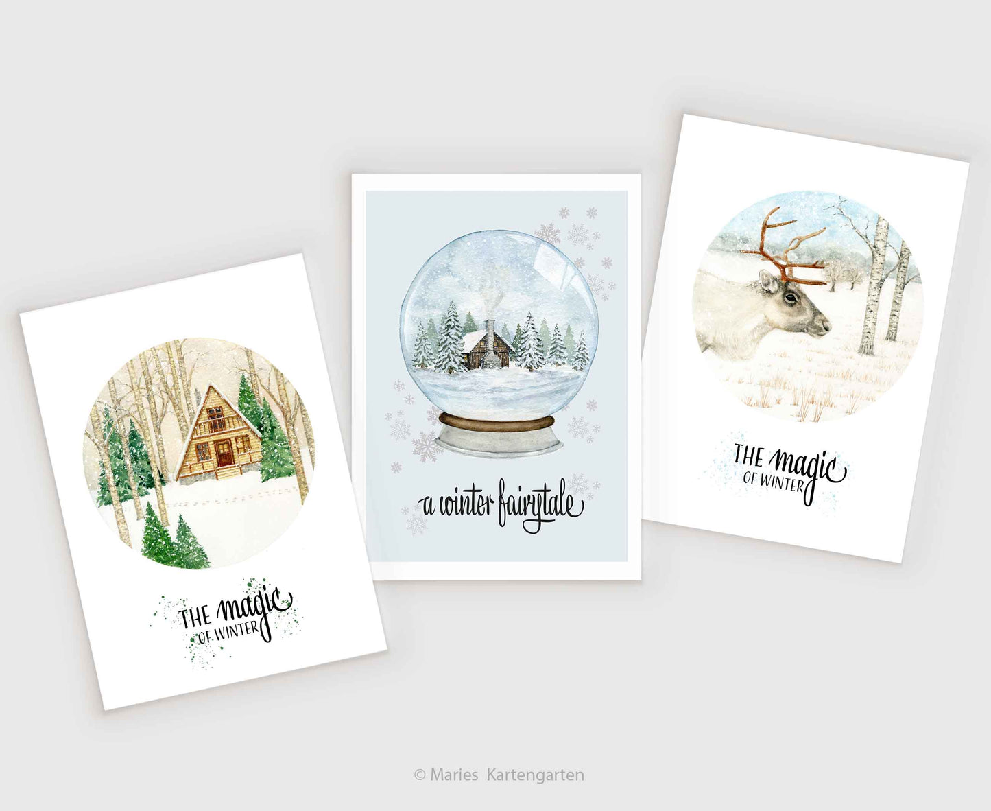 three christmas cards with a snow globe in the middle