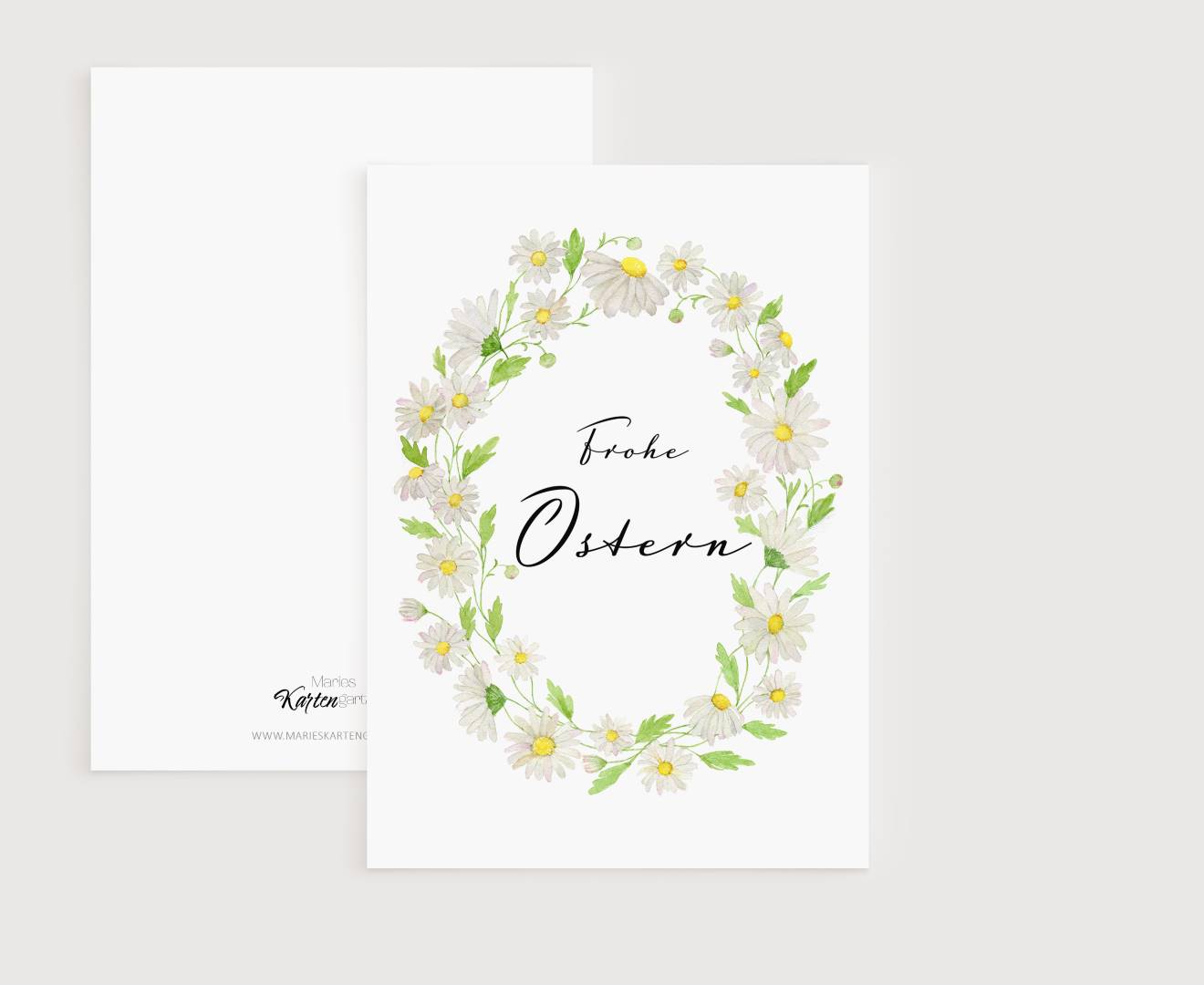 a white card with a wreath of daisies on it