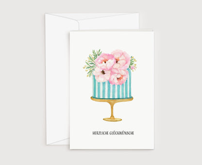 a card with a blue and white striped cake with pink flowers