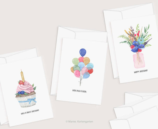 a set of four birthday cards with a cupcake and balloons